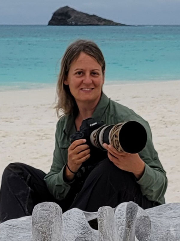 Krisztina Scheeff posing with camera on the beach