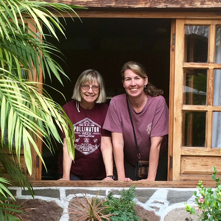 Portrait of Susan Meyers and Kim Bailey looking out a window
