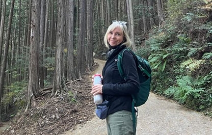 Snapshot of Cindy Linnell on a forest path