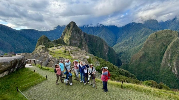 Views of landscape and travelers at Machu Picchu, Peru