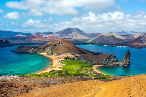 Landscape of low hills and desert islands surrounded by ocean.