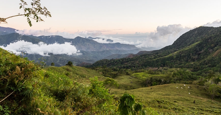 Mountains and valley with low-hanging clouds and morning light