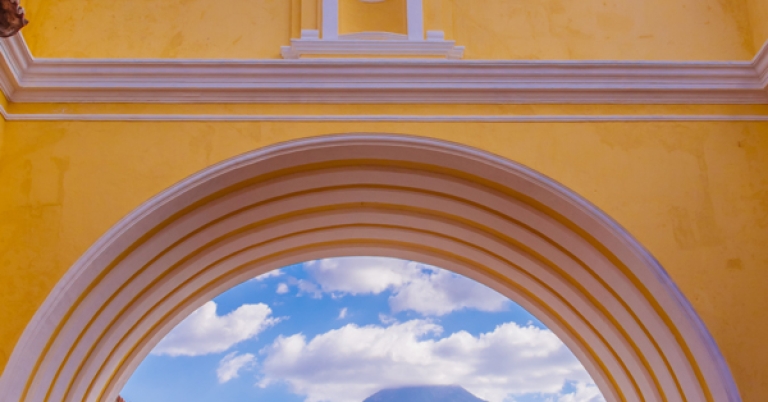 Street view of Antigua Guatemala's Santa Catalina Arch and Agua Volcano