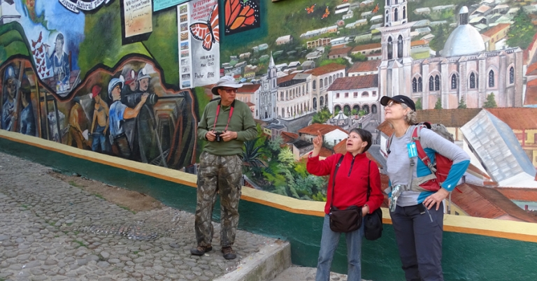 Travelers in front of local Monarch murals