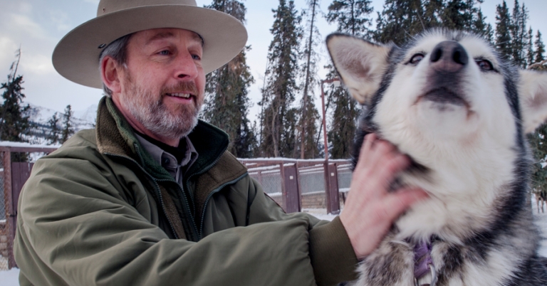 Park superintendent with sled dog in Alaska