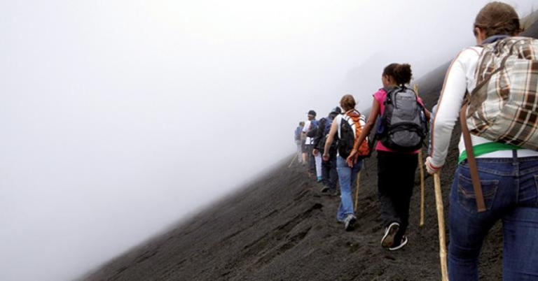 Students hiking through the mist
