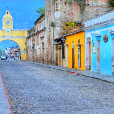 Street view of Antigua Guatemala's Santa Catalina Arch and colorful buildings