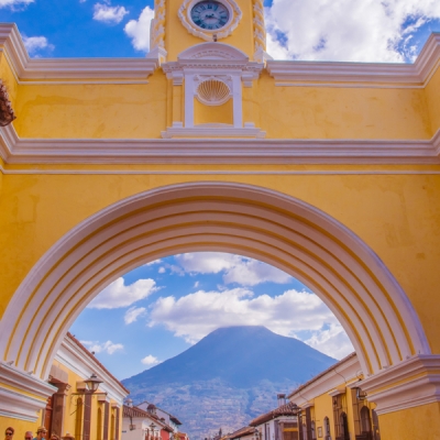 Street view of Antigua Guatemala's Santa Catalina Arch and Agua Volcano
