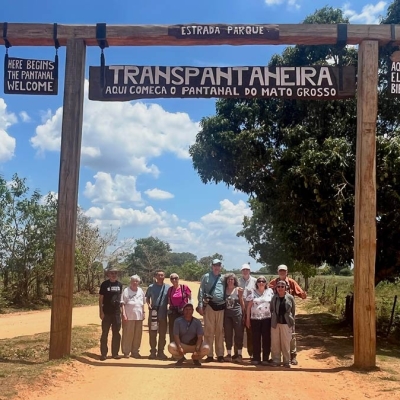 Group poses in front of a sign