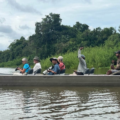 Groups sits in a boat observing wildlife