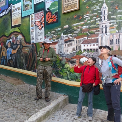 Travelers in front of local Monarch murals