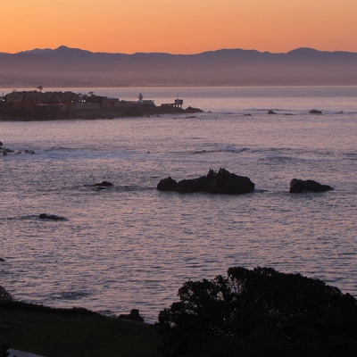 Ocean, shore, and horizon in the soft light of sunrise 
