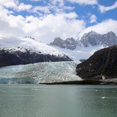 Glacier bordering a lake 