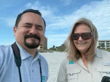 Selfie of staff Rodrigo López and Debbie Jordan on a beach